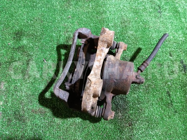 Суппорт тормозной передний левый Nissan Cefiro 