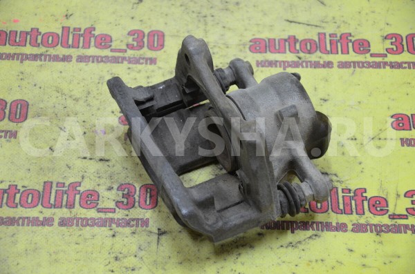 Суппорт тормозной передний левый Nissan Almera 